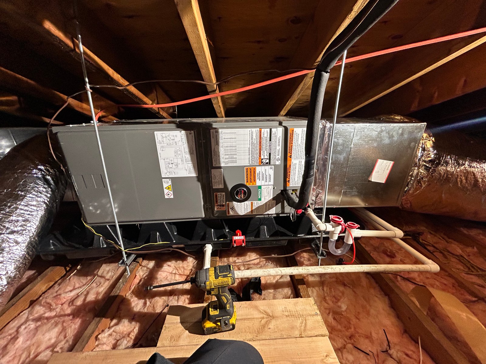 Oil-fired boiler heating system installed in a basement with copper piping, multiple circulator pumps, an expansion tank, and a venting system.